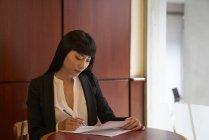 Young attractive asian businesswoman working in modern office — Stock Photo