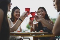 Beautiful young asian friends having drink — Stock Photo