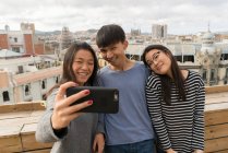 Friends taking a selfie together on balcony — Stock Photo