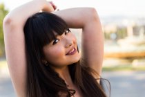 Joven hermosa asiática mujer con brazos levantados - foto de stock