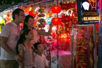 BESCHREIBUNG Glückliche Familie spaziert durch die Stadt und betrachtet schöne chinesische Neujahrsdekoration — Stockfoto