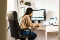 Young woman working from home with laptop — Stock Photo