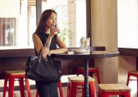 Schöne junge Frau trinkt Alkohol in Luxus-Café — Stockfoto