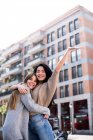 Two beautiful female friends hugging in city — Stock Photo
