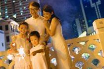 RELEASES Young asian family together with sparklers at Chinese New Year — Stock Photo
