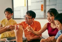 RELEASES Happy asian family eating together at table at chinese new year — Stock Photo