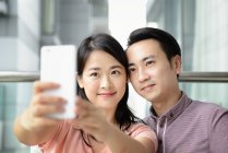 Доросла азіатська пара разом приймає селфі вдома — стокове фото