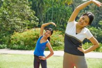 Дві жінки практикують йогу в ботанічних садах (Сінгапур). — стокове фото