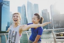 Young asian women doing stretching outdoors — Stock Photo