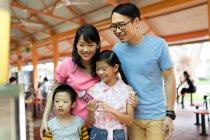 RELEASES Young asian family together looking at soda water — Stock Photo