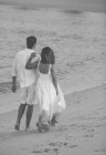 Счастливая молодая пара проводит время вместе на пляже — стоковое фото