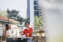 Jovem asiático feminino amigos juntos comer no café — Fotografia de Stock