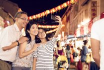 Happy asian family spending time together at chinese new year and taking selfie — Stock Photo