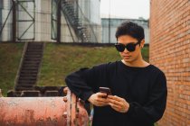 Jovem asiático elegante homem usando smartphone — Fotografia de Stock