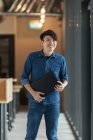 Young male asian worker with documents in office — Stock Photo