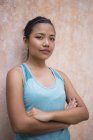 Young asian sporty woman with arms crossed — Stock Photo