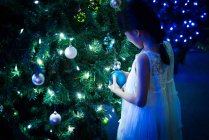 Happy asian girl playing with bubble near fir tree in amusement park at christmas — Stock Photo