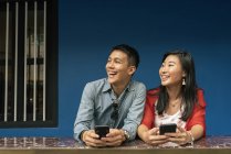 Asian Chinese Couple spending time together in Chinatown with smartphones — Stock Photo