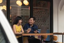 Happy asian young couple together in cafe — Stock Photo