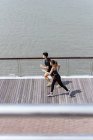 Elevated view of asian couple running together — Stock Photo