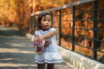 Cute little asian girl in park with toy — Stock Photo
