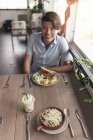 Ritratto di giovane bello asiatico uomo in ristorante — Foto stock
