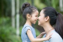 Cute asian mother and daughter spending time together at park — Stock Photo