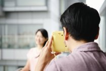 Adult asian couple taking photo at home on balcony — Stock Photo