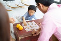 Счастливая семья Азии проводить время вместе и игра настольная игра — стоковое фото