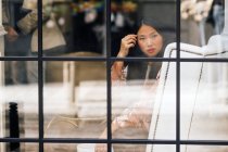 Bastante longo cabelo mulher chinesa retrato através da janela — Fotografia de Stock