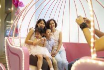 Happy young asian family taking photo together — Stock Photo