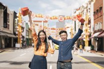 Young asian couple celebrating Chinese New Year together in chinatown — Stock Photo