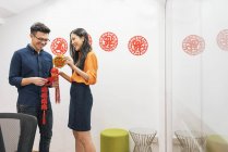 Young asian couple celebrating Chinese New Year together and decorating home — Stock Photo