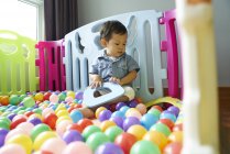 Baby having fun roaming around in a play pen — Stock Photo
