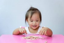 Young little asian toddler girl playing with educational toys — Stock Photo