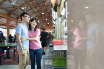 Young asian couple together at mall — Stock Photo