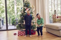 Happy asian brothers celebrating christmas together — Stock Photo