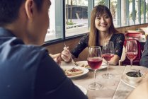 Happy young asian friends together in cafe — Stock Photo
