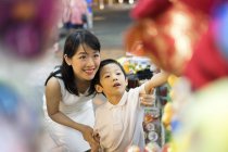 Young mother and son looking for presents — Stock Photo
