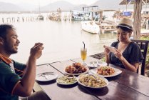 Young couple taking photos of their food in Koh Chang, Thailand — Stock Photo