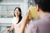 Adult asian couple together at home taking photo — Stock Photo