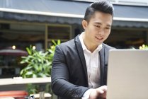 Young asian successful business  man using laptop — Stock Photo