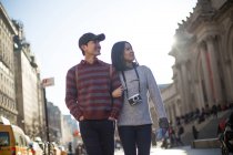 Attractive tourist couple being playful while walking together, New York, USA — Stock Photo
