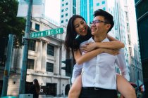 Young asian business couple hugging together — Stock Photo