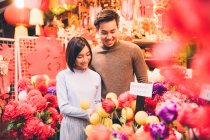 Feliz asiático pareja celebrando chino año nuevo en ciudad - foto de stock