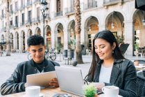 Happy young asian tourist couple on the tablet in Barcelona, spain — Stock Photo