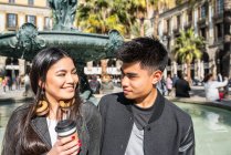 Happy young asian tourist couple drinking coffee in Barcelona, spain — Stock Photo