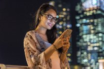 Young Woman Playing With Her Smartphone In Urban City — Stock Photo