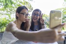 Young attractive asian women taking selfie in cafe — Stock Photo