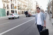 Chinese businessman calling a taxi in Serrano street, Madrid, Spain — стоковое фото